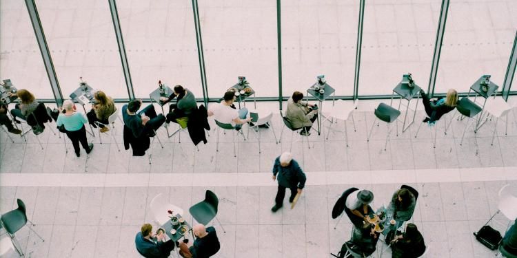 Overhead shot of busy cafeteria and business people - Ofgem