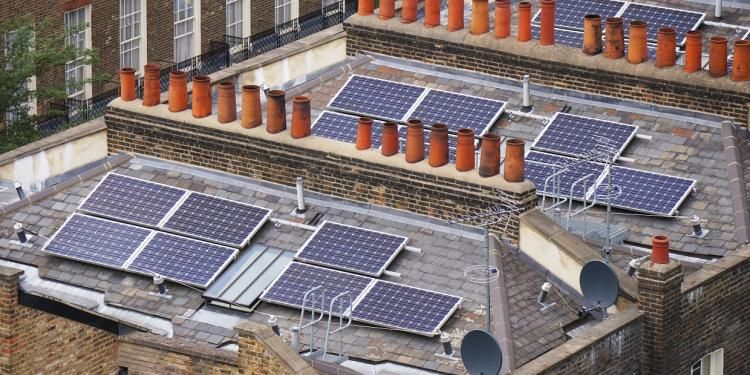 Residential rooftops with solar panels in the city - Ofgem