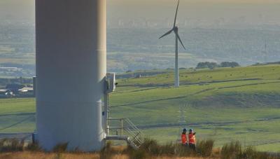 Wind turbines in countryside and engineers - Ofgem