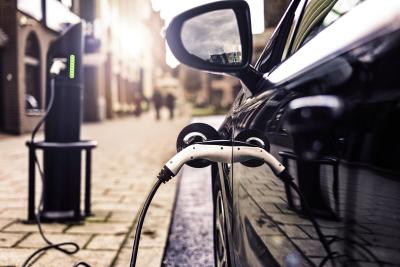Electric car plugged into a power point