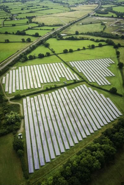 Aerial view over solar farm photovoltaic power station solar panels