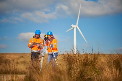 two engineers in front of wind turbine