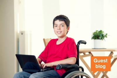 Boy with laptop in wheelchair
