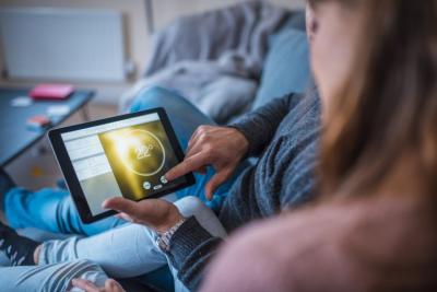 Couple looking at tablet with smart home controls.