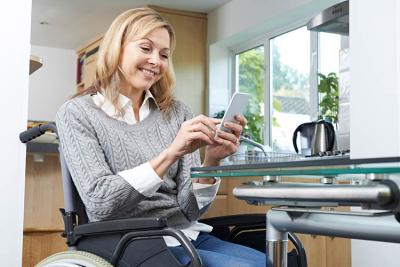 Woman in wheelchair looking at her phone